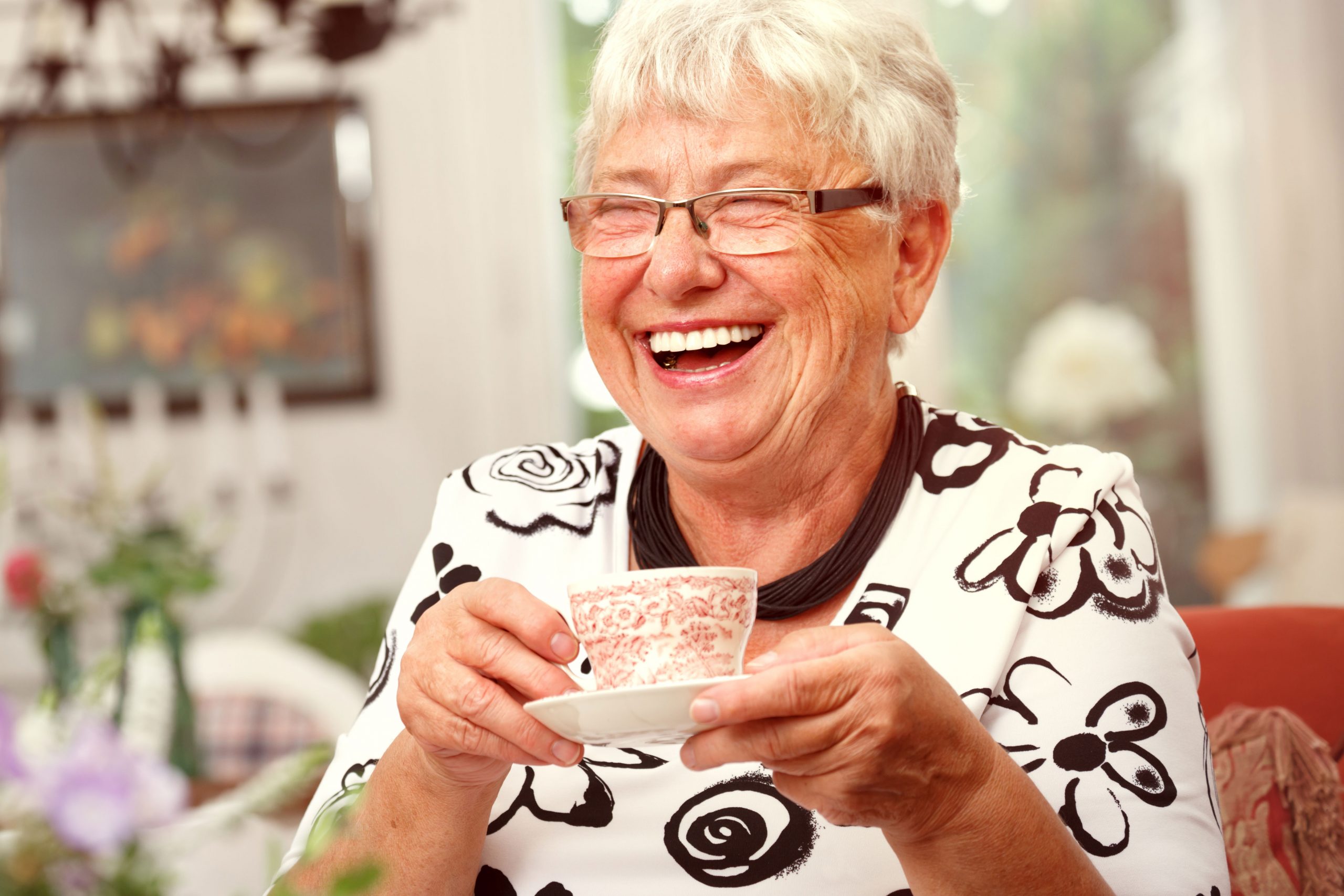 Happy Senior woman drinking tea