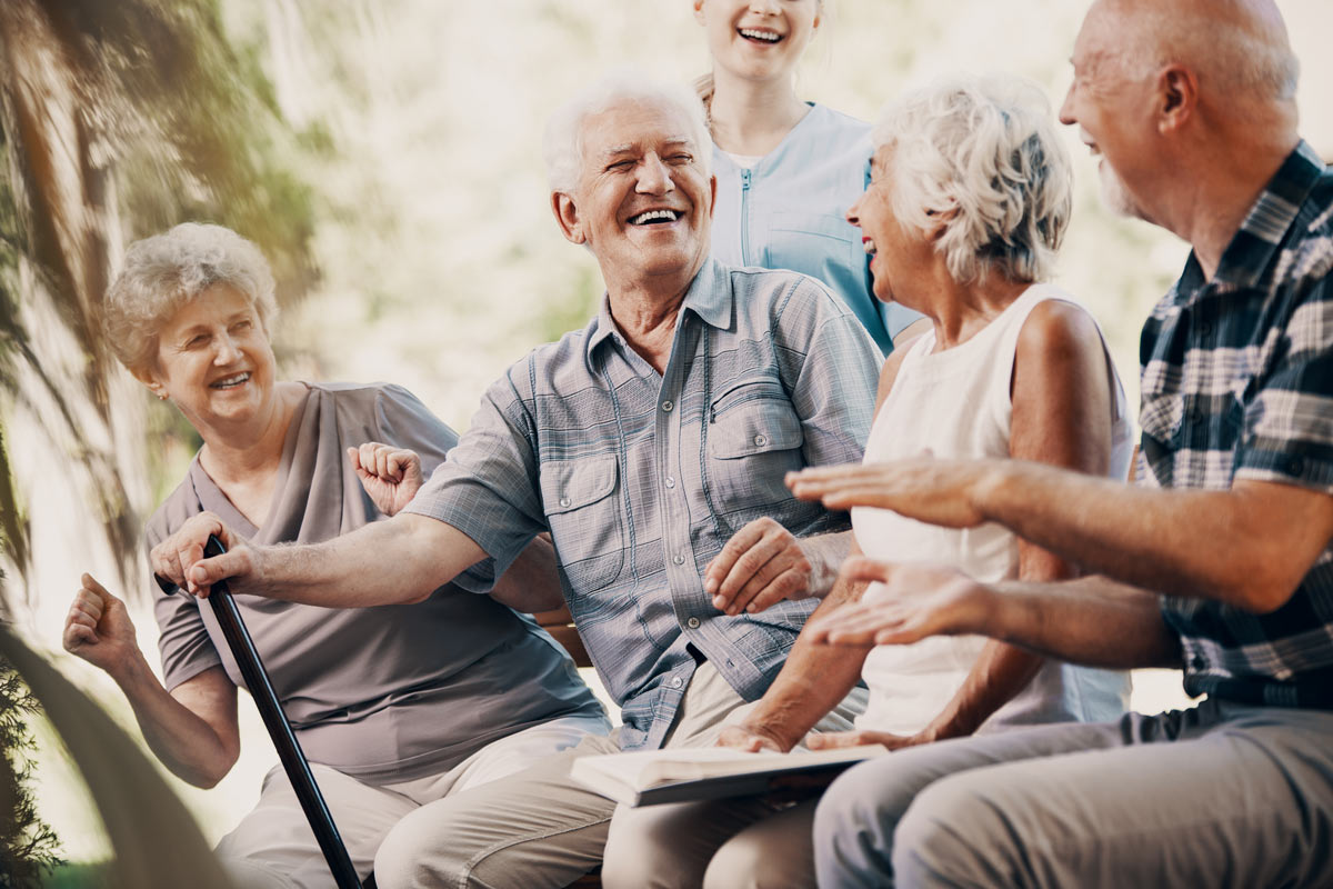 Seniors Sitting Outside Laughing at Edmonton VRS Retirement Community