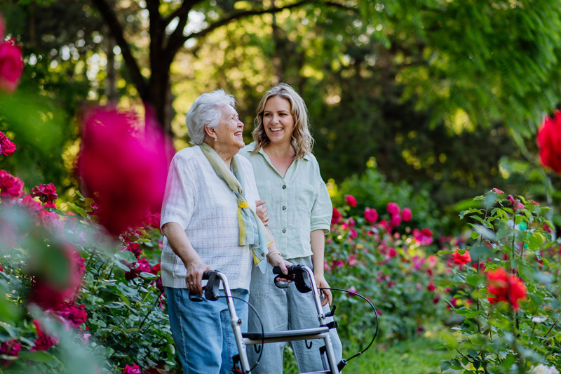 Senior safely walking outside with a walker at a senior independent or assisted living community in Edmonton