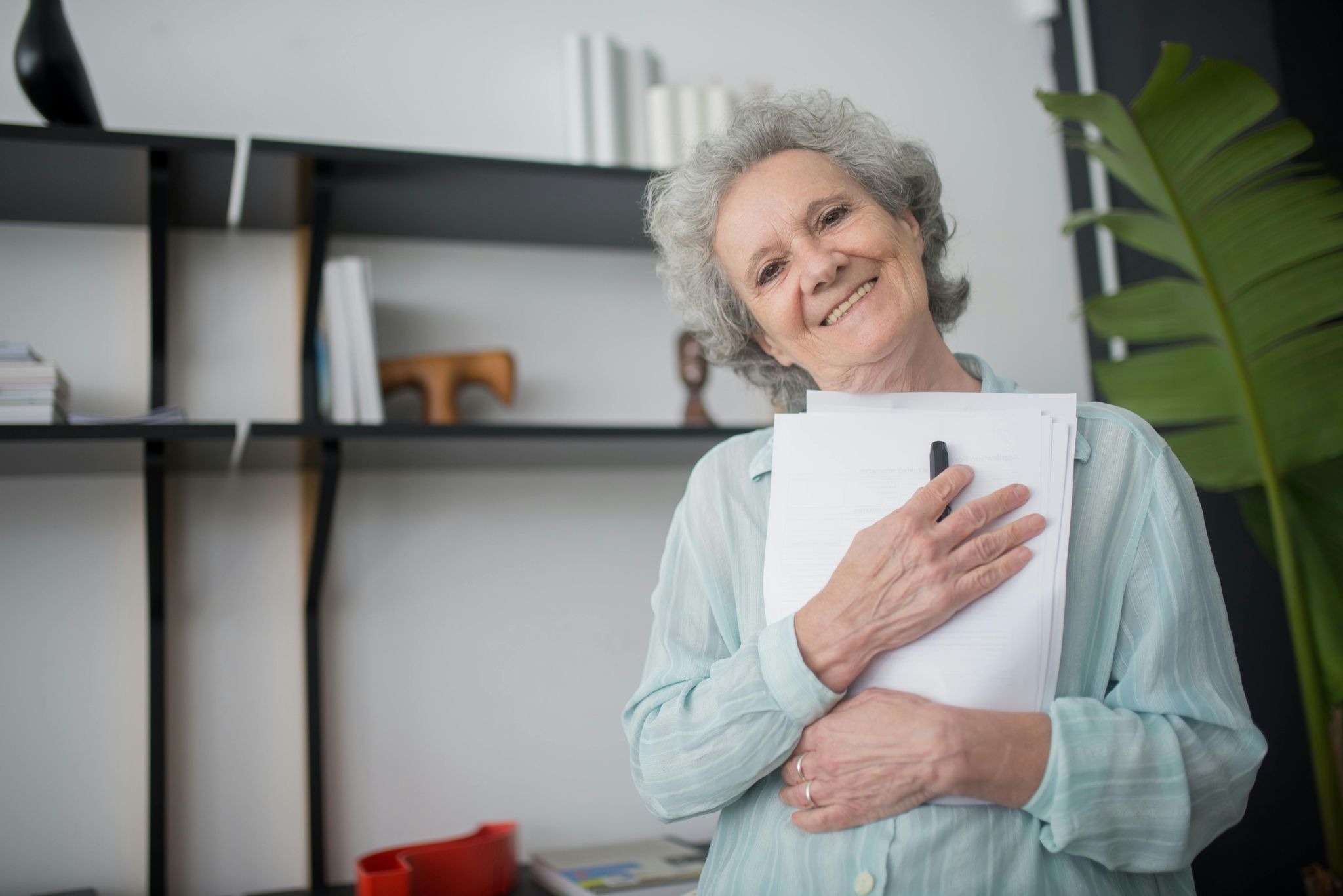 woman happily smiling with paper